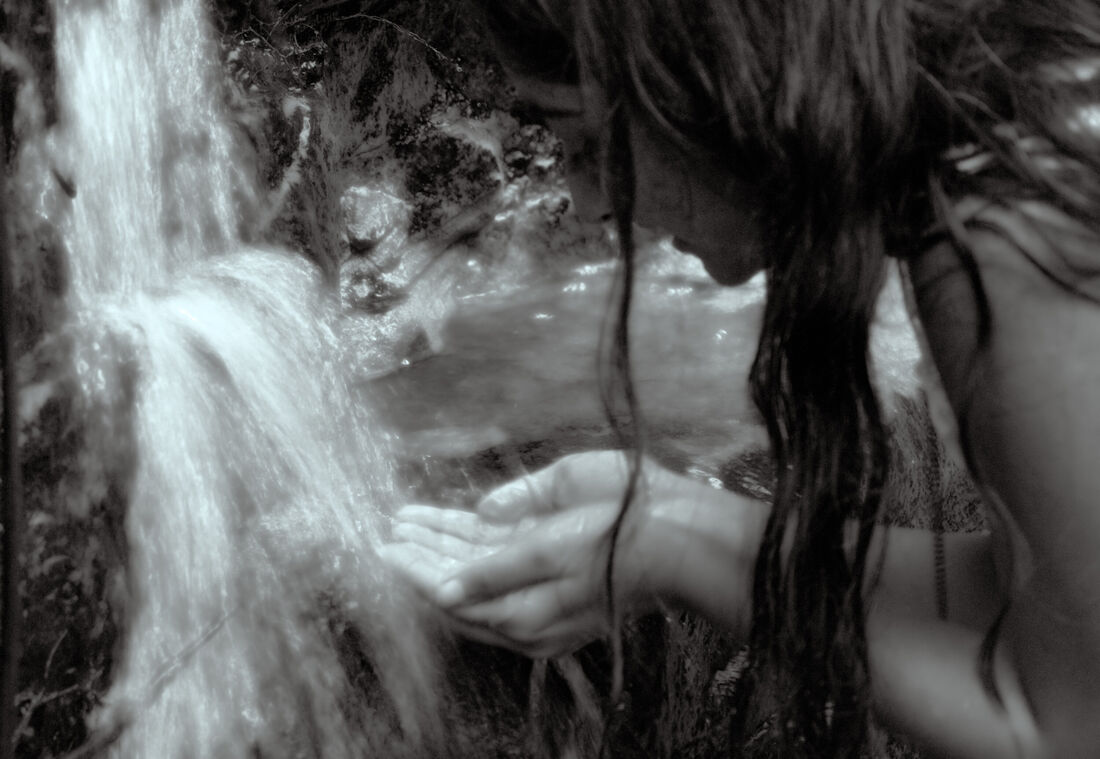 Girl Drinking From Waterfall